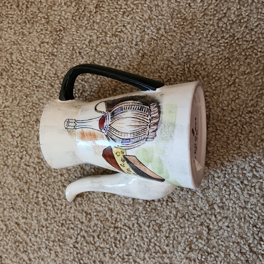 Teapot with creamer and sugar.